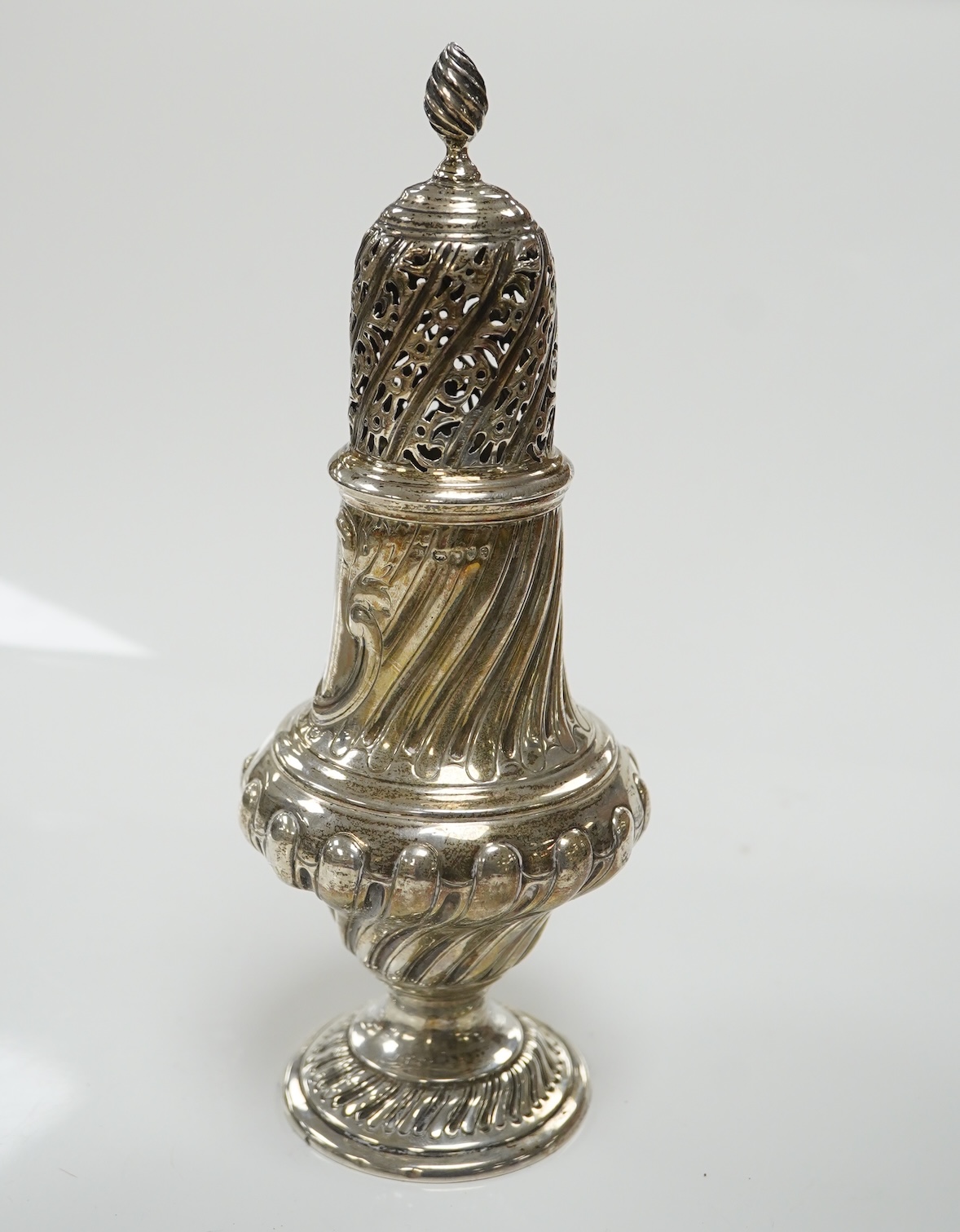 A Victorian repousse spiral fluted pedestal sugar caster, Thomas Bradbury & Sons, London, 1889, 18.3cm, 3.9oz. Condition - fair